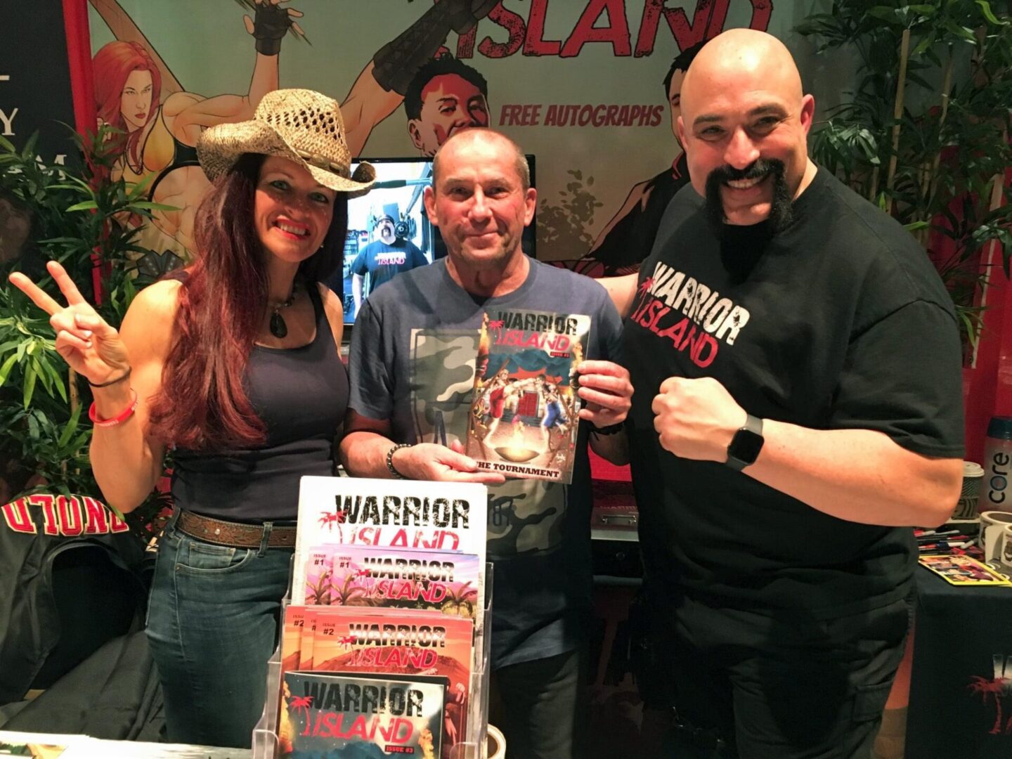 Picture of three people holding warrior island